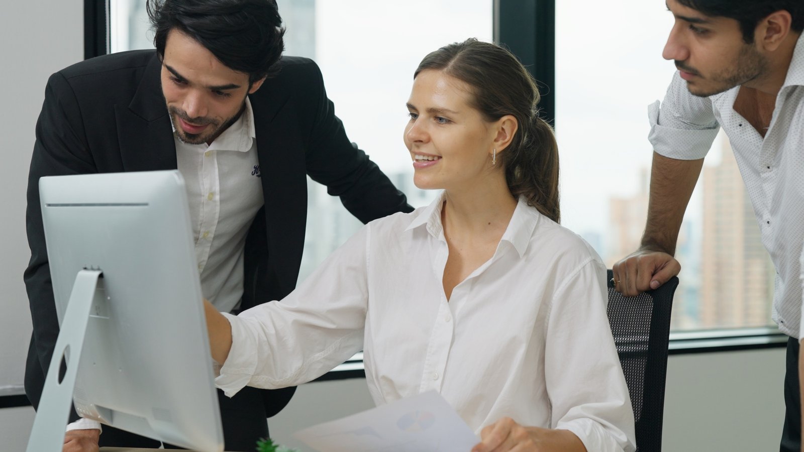 Happy employees working together at high building office